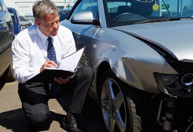 car insurance claim form being signed and dated